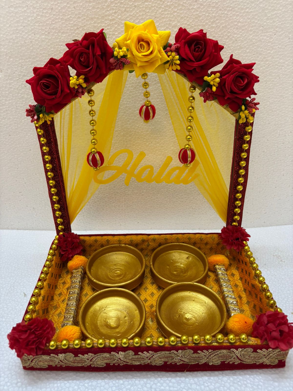 Handmade Haldi Platter decorated with red and yellow roses, golden beads, and four golden bowls for wedding and festive rituals