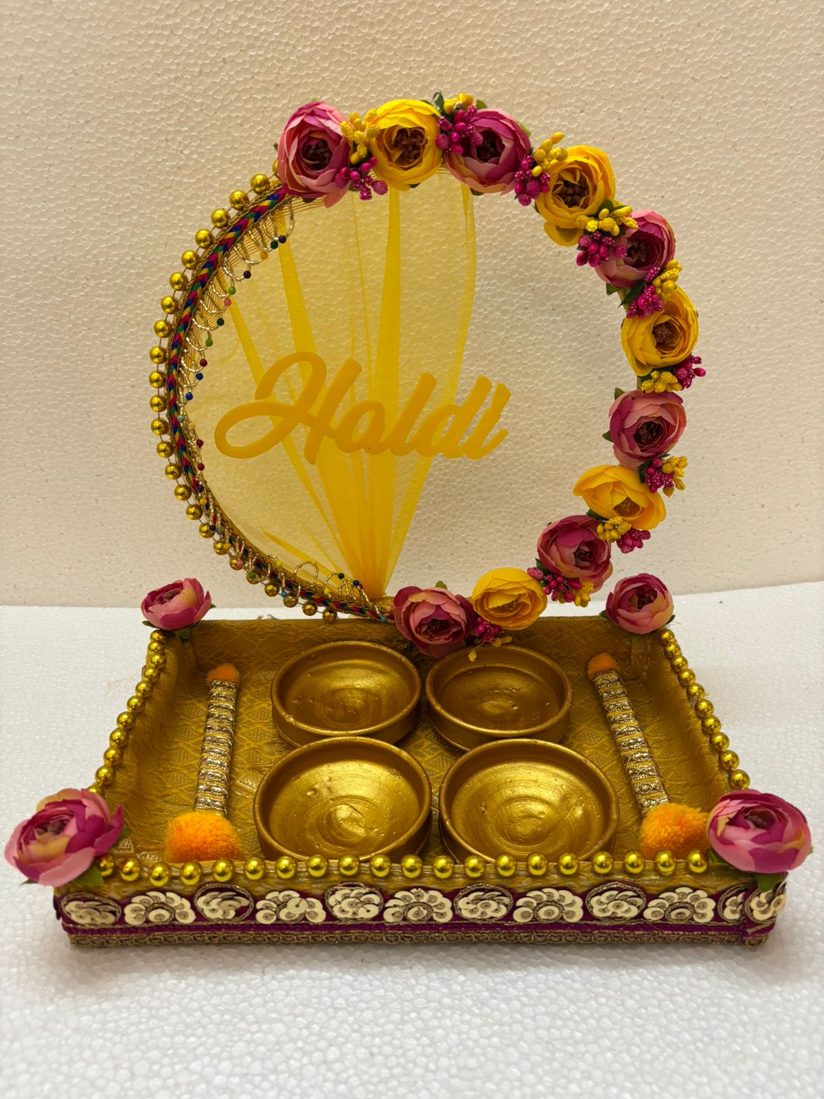 Handmade Haldi Platter decorated with pink and yellow flowers, bead detailing, and four golden bowls for wedding and festive rituals