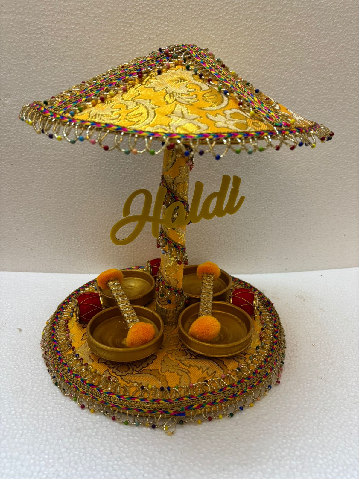 Handmade Haldi Platter with yellow canopy, colorful bead border, and four golden bowls for wedding and festive rituals