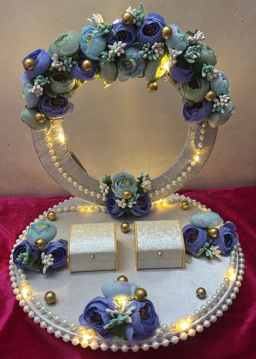 A decorative ring platter with floral designs, LED lights, and boxes for rings.