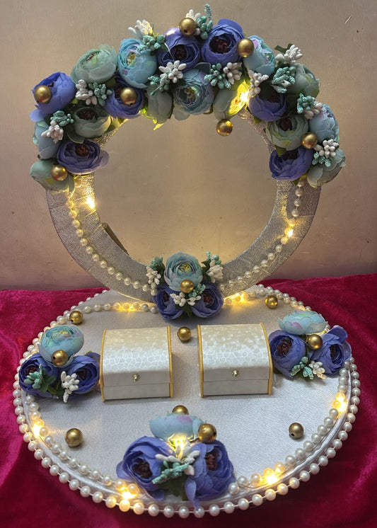 A decorative ring platter with floral designs, LED lights, and boxes for rings.