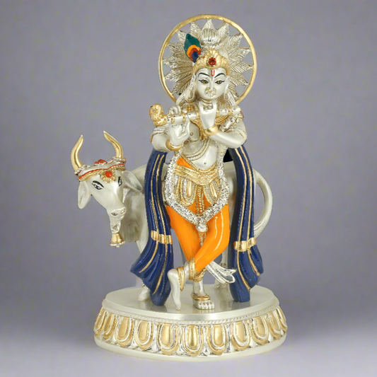 A 999 Pure Silver Plated figure of Lord Shri Krishna sitting on a cow with decorative clothing and a halo above his head, placed on a round base.