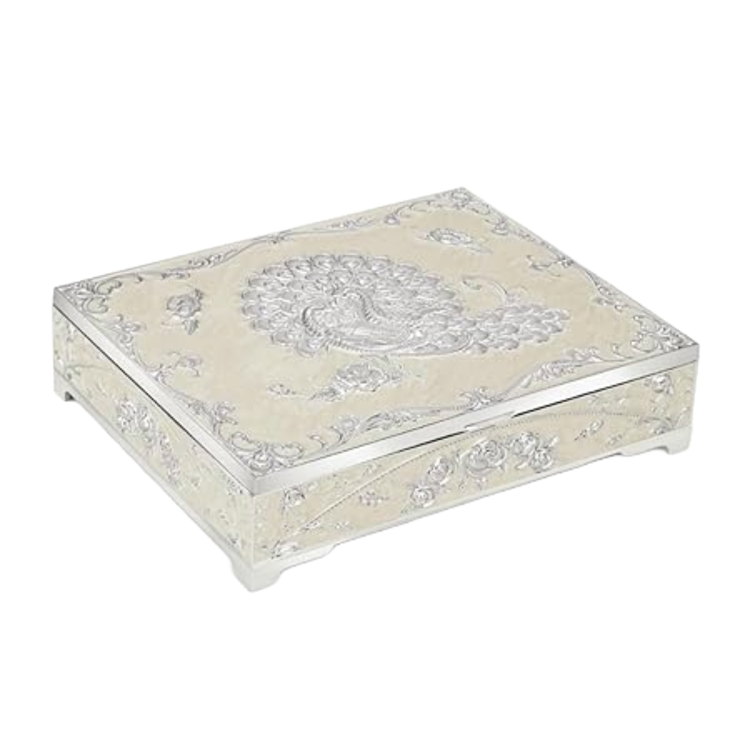 An elegant white metal dry fruit box with silver detailing and a design of a peacock in the center.